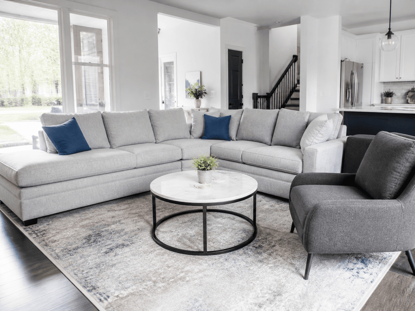 Clean sectional sofa paired with an upholstered chair